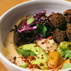 Garden Bowl: falafel, red cabbage, avocado cream and hummus in a white bowl